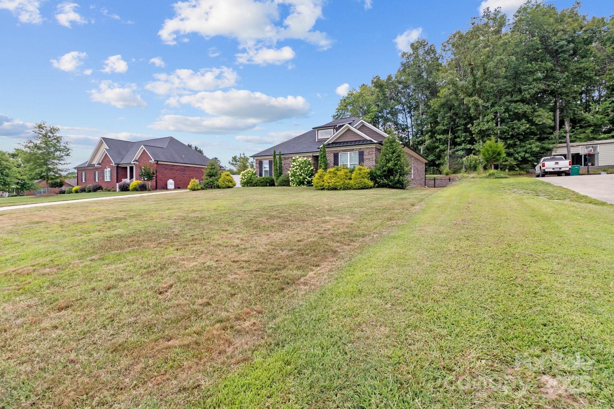 203 Poplins Grove Church Road Albemarle, NC 28001 - Photo 18 of 48 a front view of a house with a garden and porch