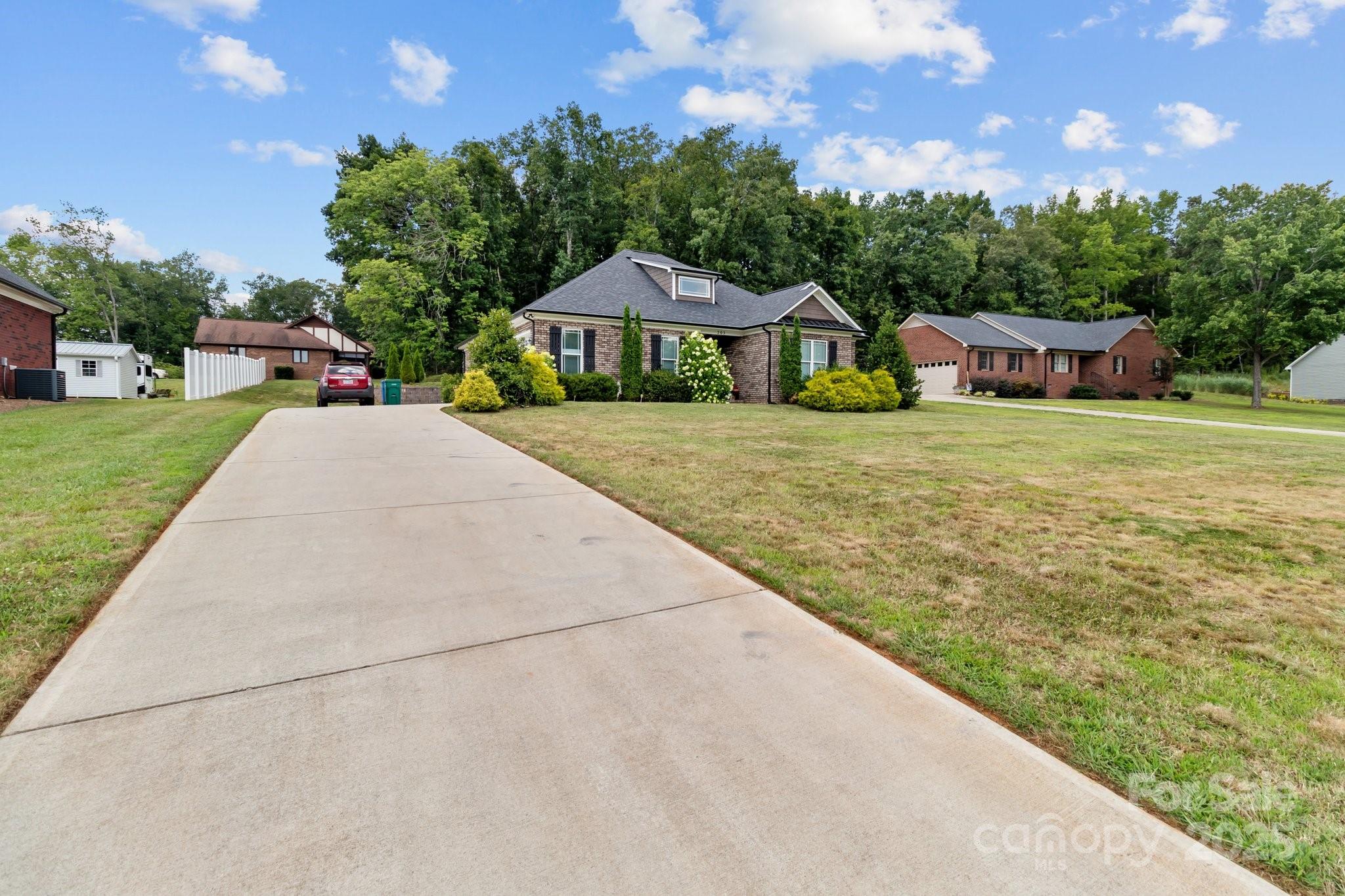 203 Poplins Grove Church Road Albemarle, NC 28001 - Photo 20 of 48 a front view of a house with a yard and trees