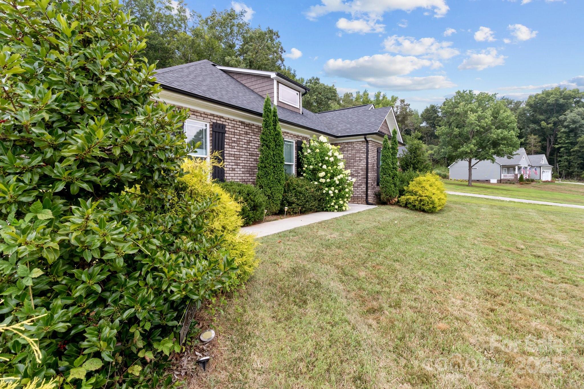 203 Poplins Grove Church Road Albemarle, NC 28001 - Photo 21 of 48 a view of a house with a yard and potted plants