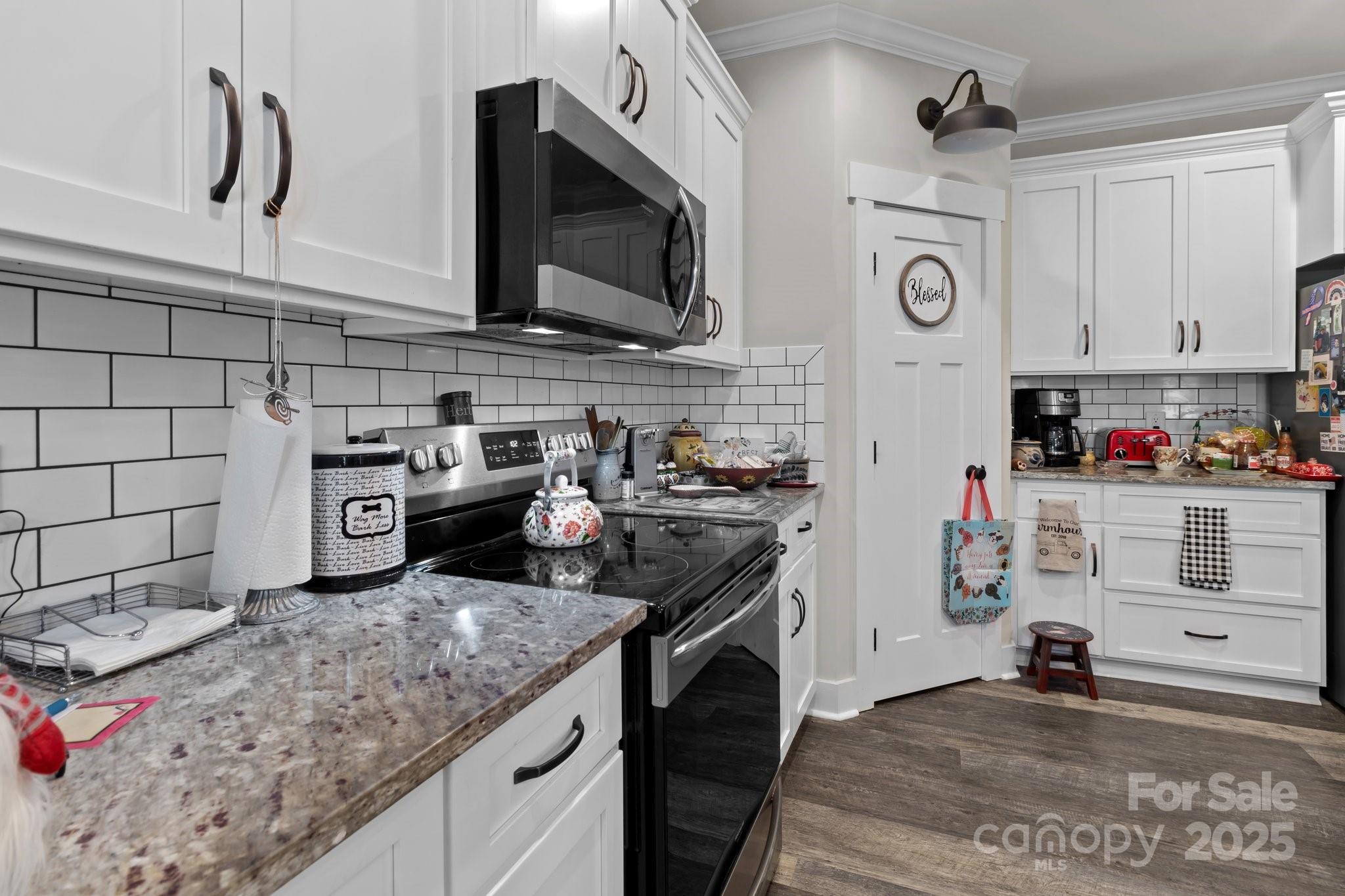 203 Poplins Grove Church Road Albemarle, NC 28001 - Photo 38 of 48 a kitchen with stainless steel appliances granite countertop a sink and a stove