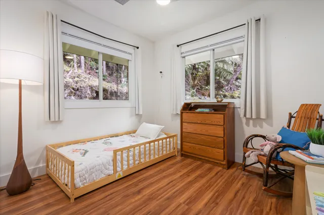 a bedroom with furniture and a window