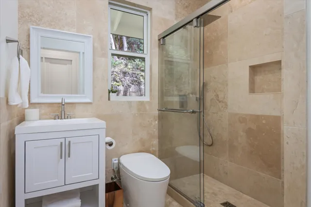 a bathroom with a toilet sink and shower