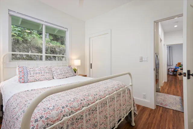 a bedroom with a bed and a large window