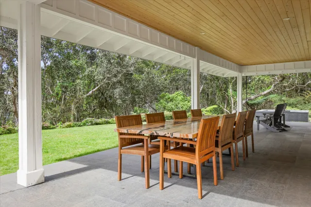 a swimming pool with outdoor seating and yard