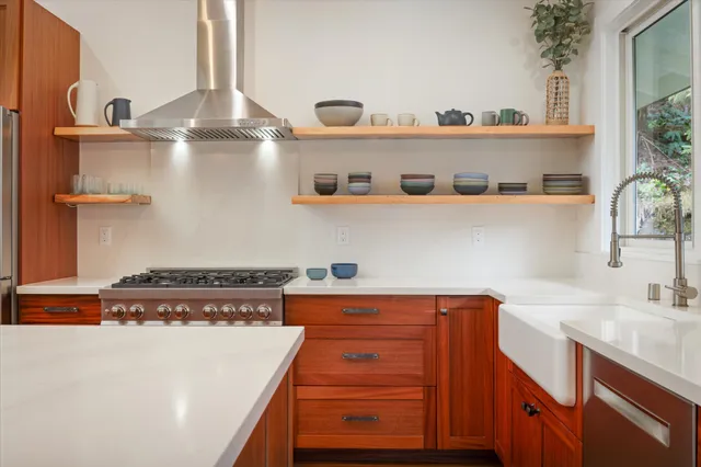 a kitchen with stainless steel appliances granite countertop a sink and a stove