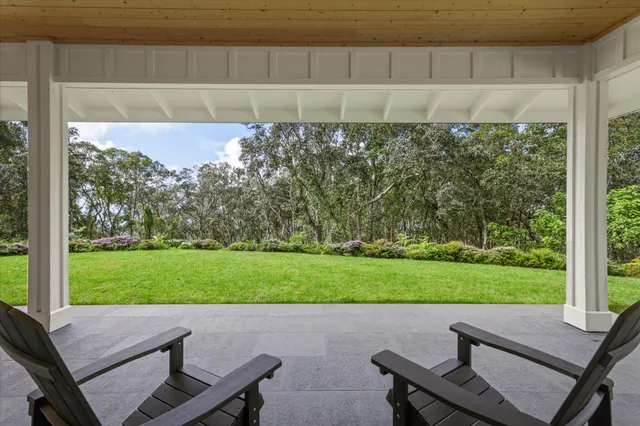 a view of a house with a yard and garage
