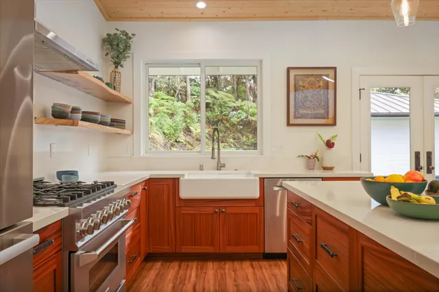 a kitchen with stainless steel appliances granite countertop a sink stove and cabinets