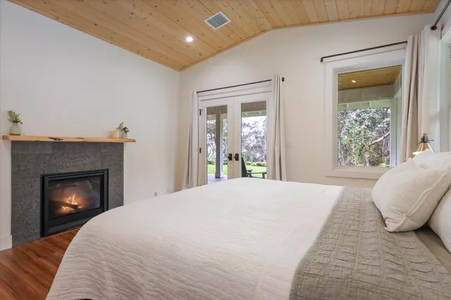 a bedroom with a bed and a fireplace