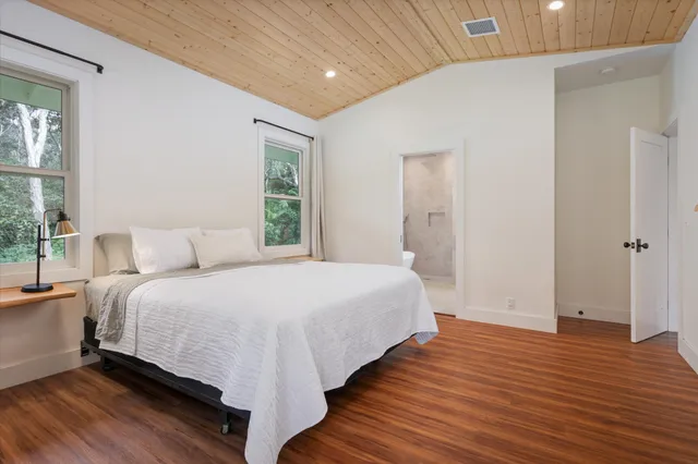 a spacious bedroom with a bed and a window