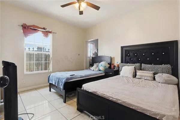 a bedroom with two beds and a chandelier