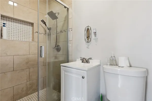 a bathroom with a sink a toilet and shower