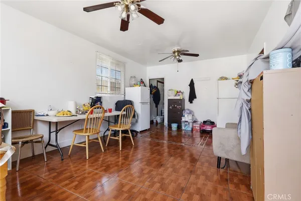 a view of a dining room with furniture and a chandelier fan