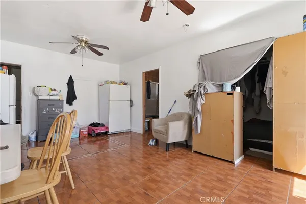 a bedroom with furniture and a fan