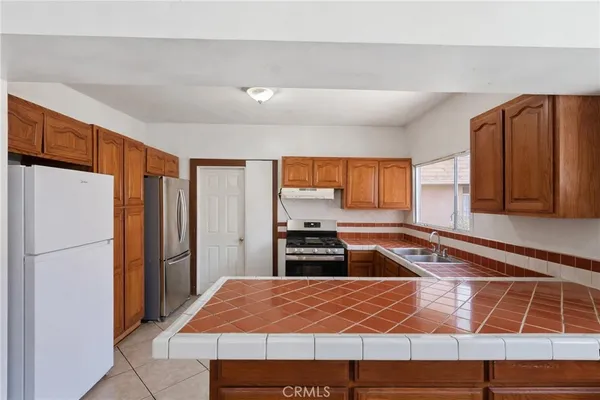 a kitchen with a refrigerator and a stove