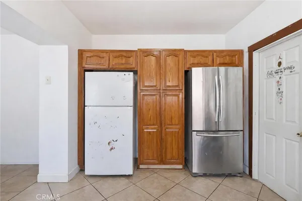 a metallic refrigerator freezer sitting in a kitchen