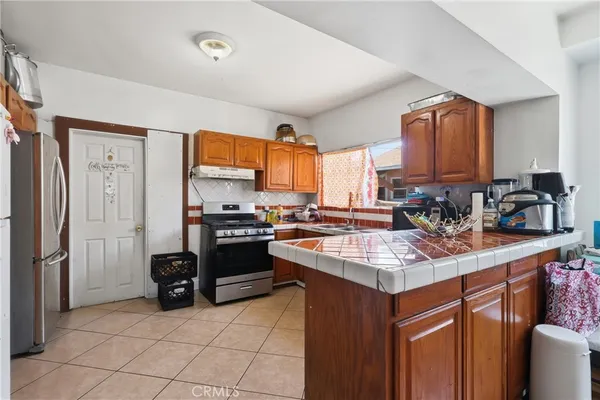 a kitchen with stainless steel appliances granite countertop a stove sink and cabinets