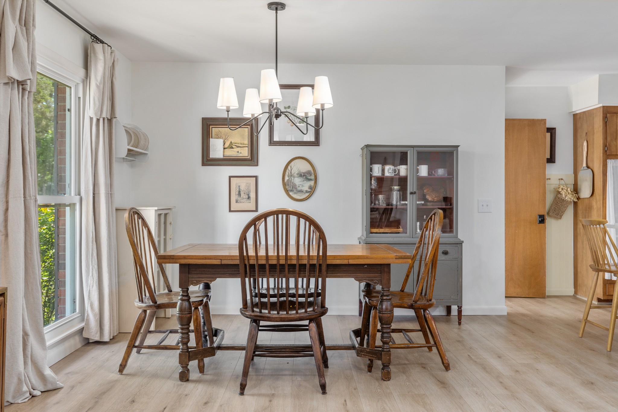 817 Fredricksburg Road Mount Juliet, TN 37122 - Photo 17 of 56 a view of a dining room with furniture a chandelier and wooden floor
