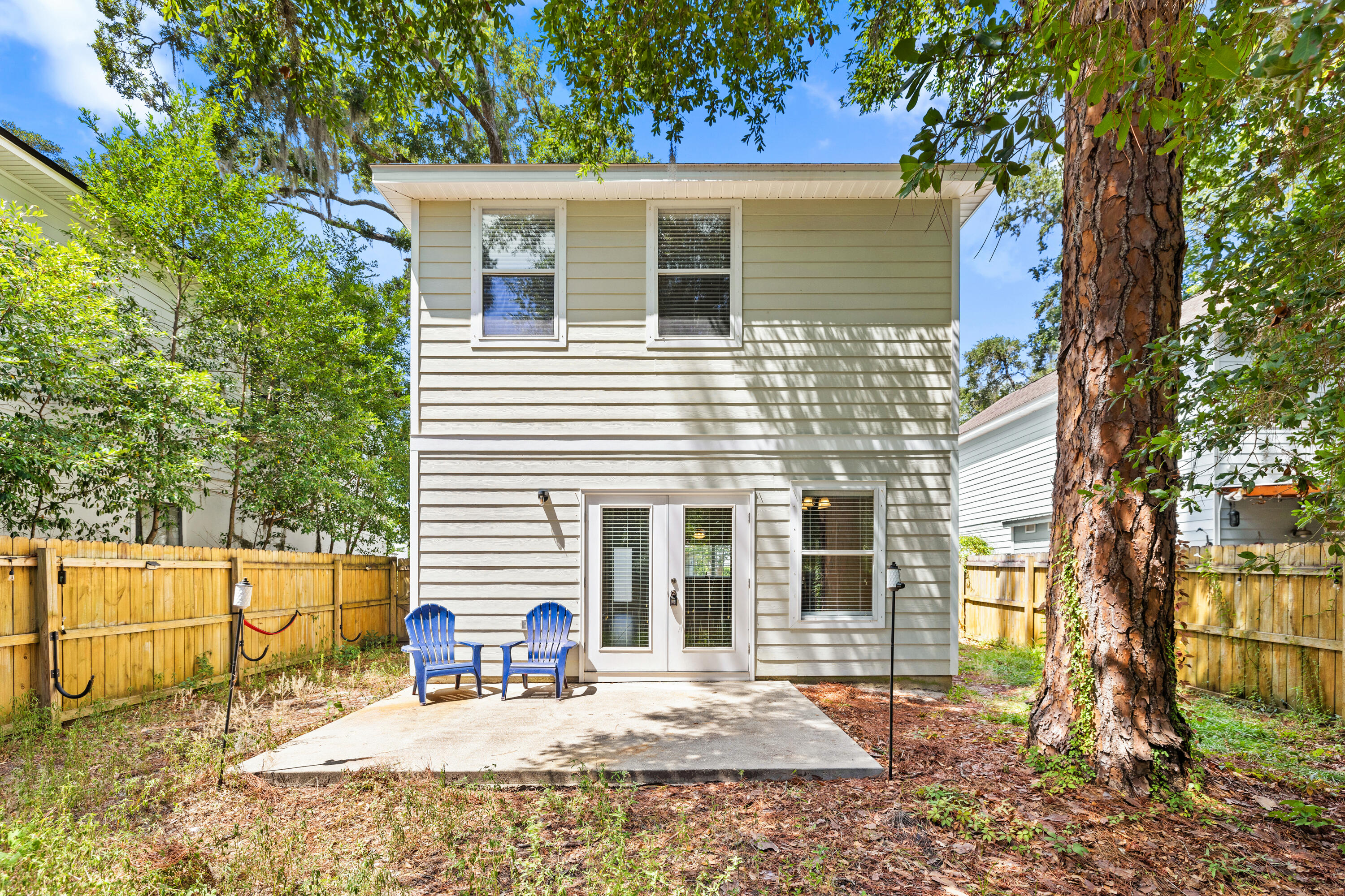 62 Beacon Point Drive Santa Rosa Beach, FL 32459 - Photo 12 of 51 front view of a house with a chairs and table in a patio