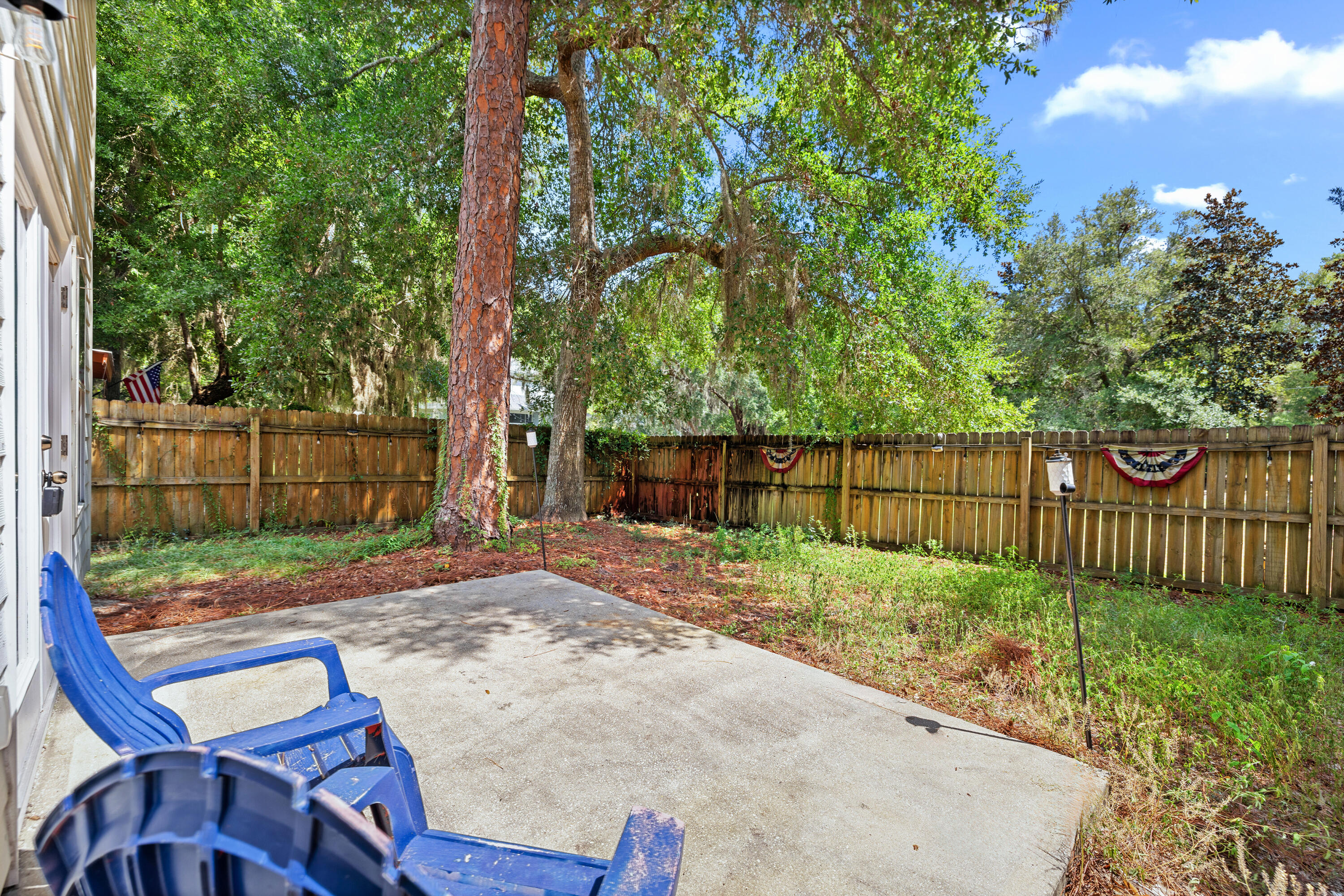 62 Beacon Point Drive Santa Rosa Beach, FL 32459 - Photo 16 of 51 a view of a backyard with wooden fence and a bench