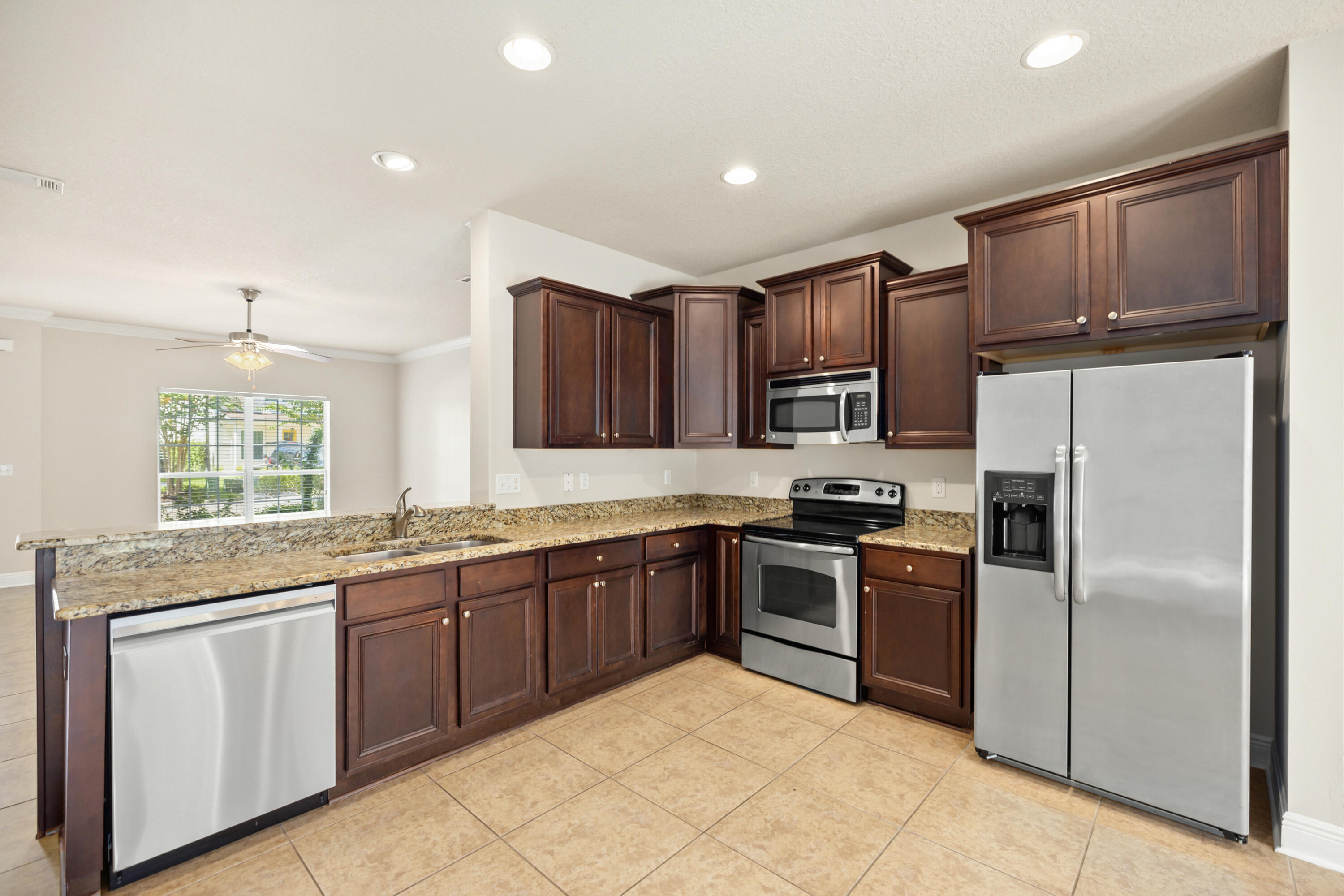 62 Beacon Point Drive Santa Rosa Beach, FL 32459 - Photo 28 of 51 a kitchen with granite countertop stainless steel appliances cabinets a sink and a window