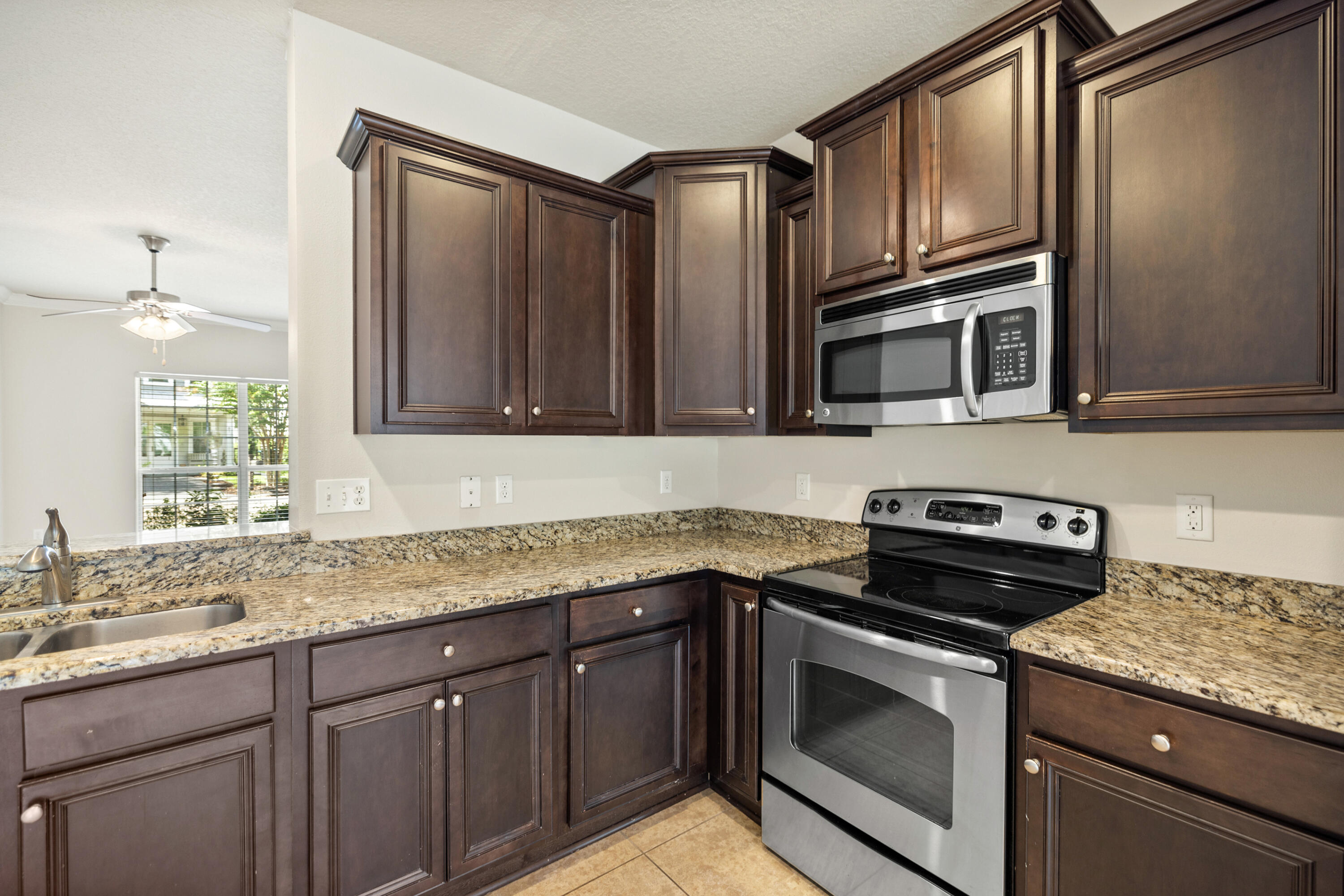 62 Beacon Point Drive Santa Rosa Beach, FL 32459 - Photo 29 of 51 a kitchen with granite countertop cabinets stainless steel appliances and a sink