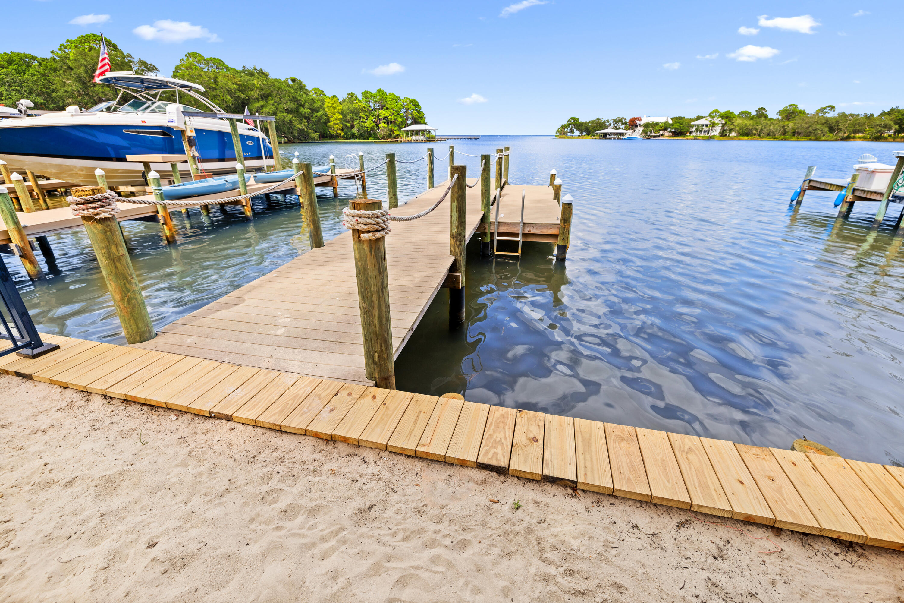 62 Beacon Point Drive Santa Rosa Beach, FL 32459 - Photo 50 of 51 a view of a lake with boats and trees in the background