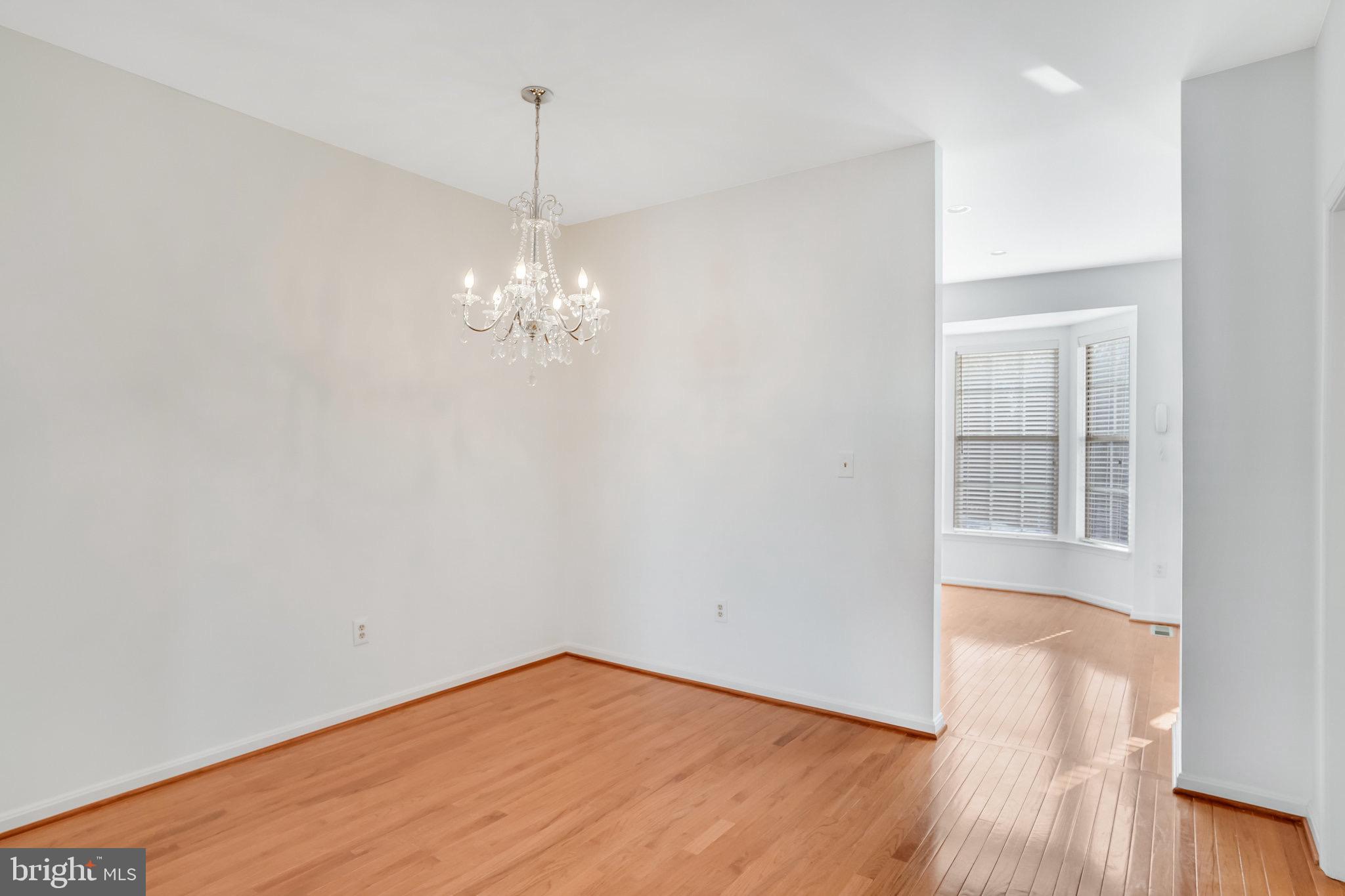 6324 Dakine Circle Springfield, VA 22150 - Photo 11 of 25 a view of a room with wooden floor and chandelier
