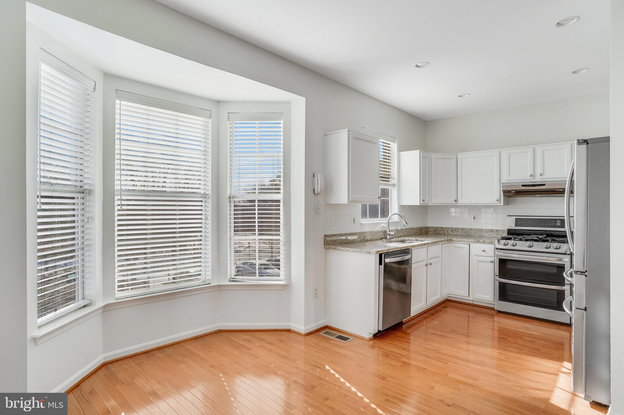 6324 Dakine Circle Springfield, VA 22150 - Photo 12 of 25 a kitchen with a stove a sink and a microwave