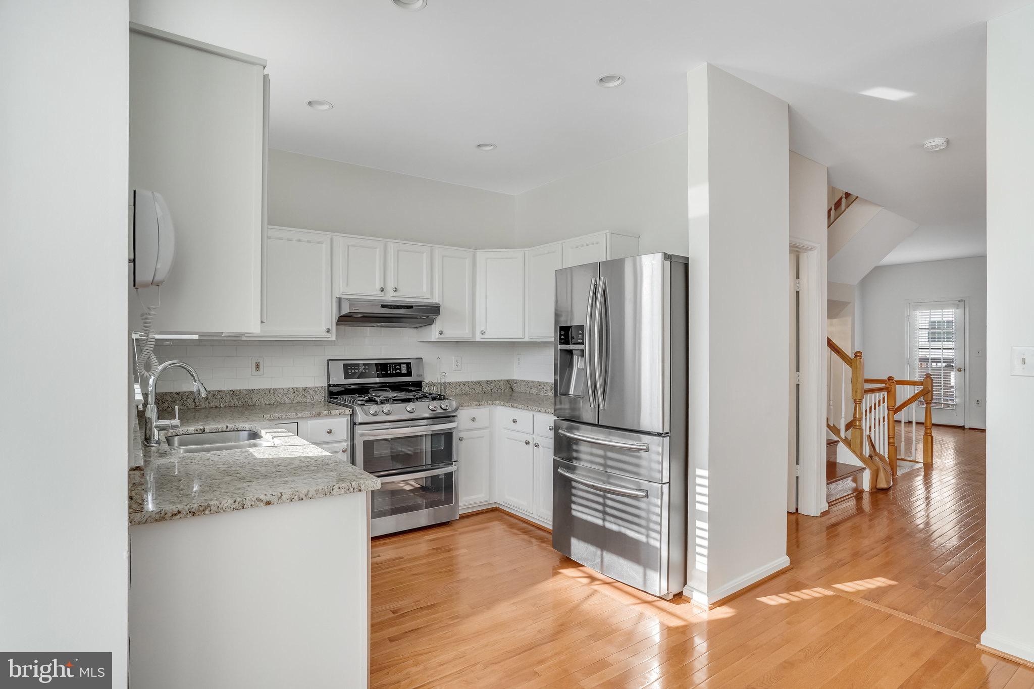 6324 Dakine Circle Springfield, VA 22150 - Photo 14 of 25 a kitchen with a refrigerator stove and wooden cabinets