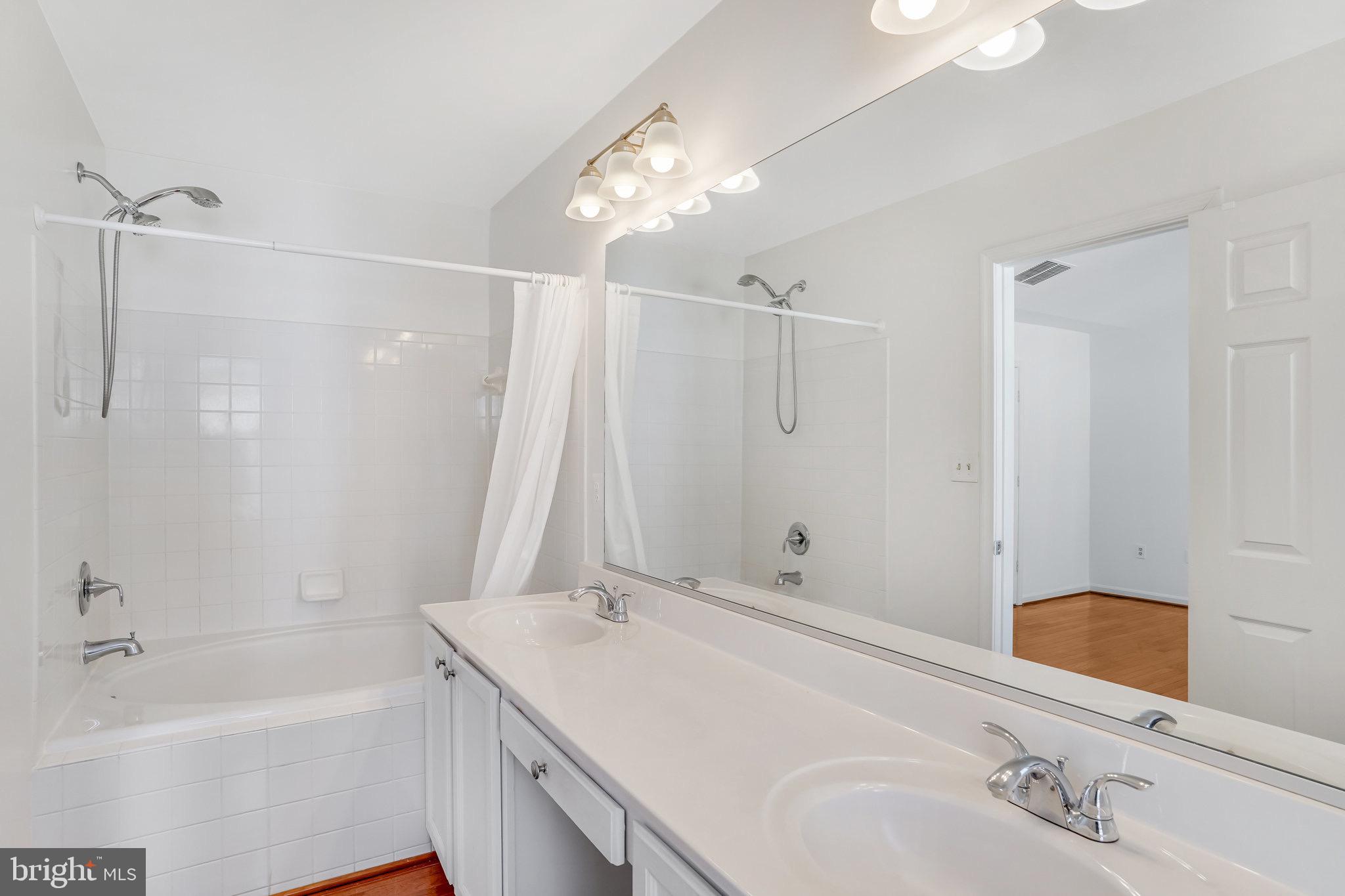 6324 Dakine Circle Springfield, VA 22150 - Photo 18 of 25 a bathroom with a tub sink and mirror