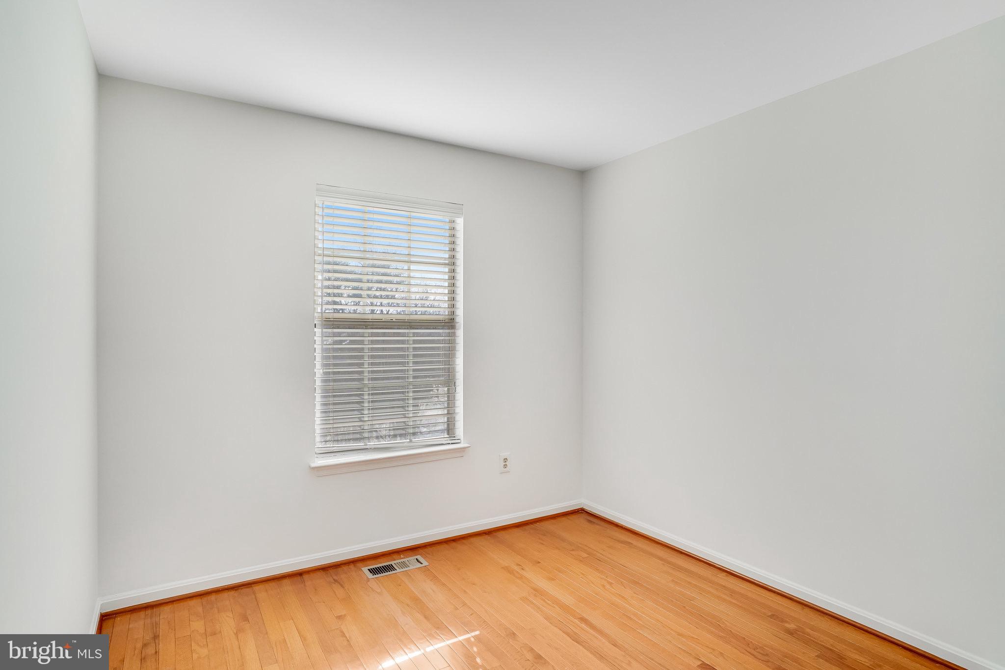 6324 Dakine Circle Springfield, VA 22150 - Photo 20 of 25 a view of an empty room with wooden floor and a window