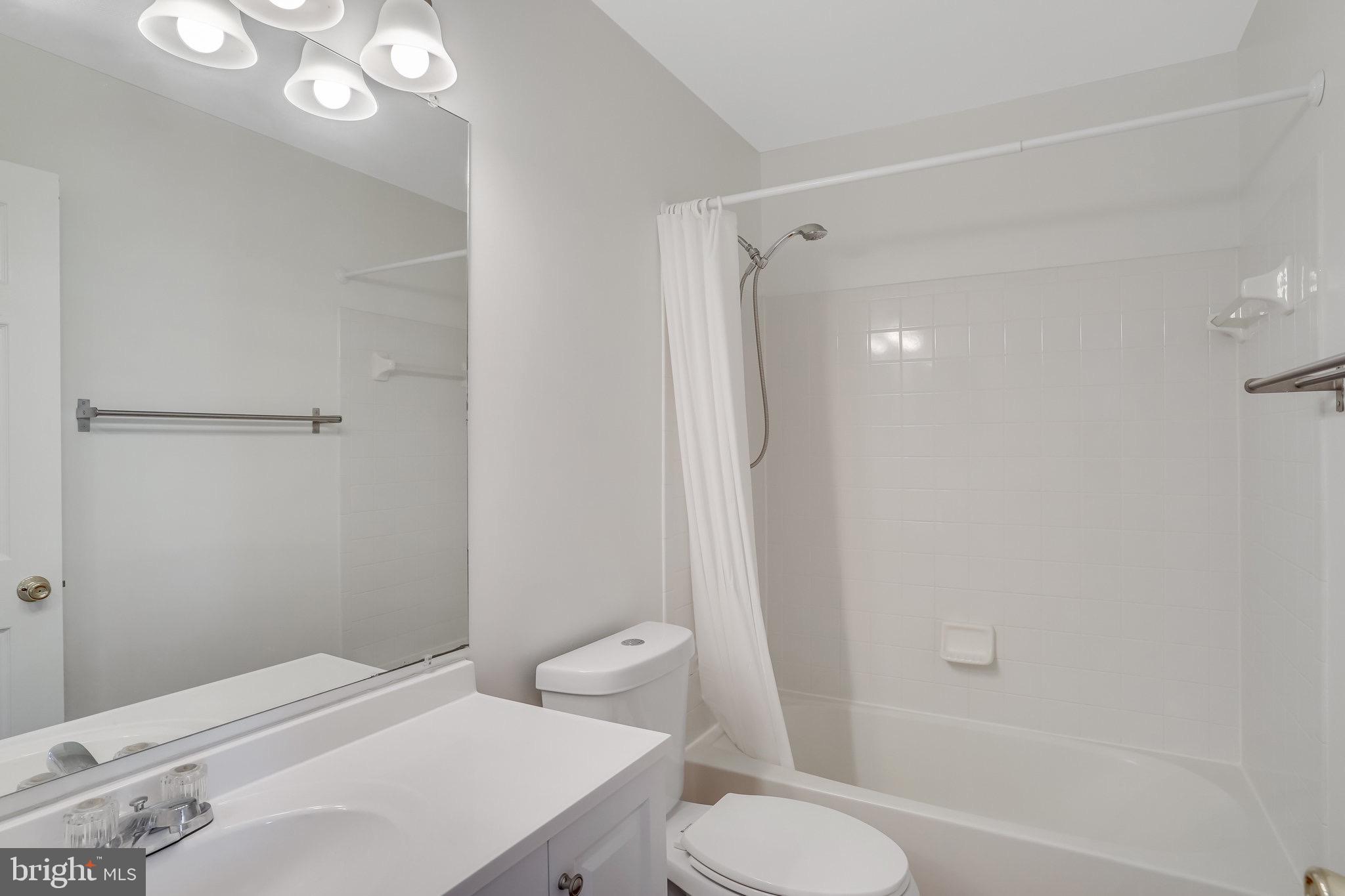 6324 Dakine Circle Springfield, VA 22150 - Photo 22 of 25 a bathroom with a toilet sink vanity and shower