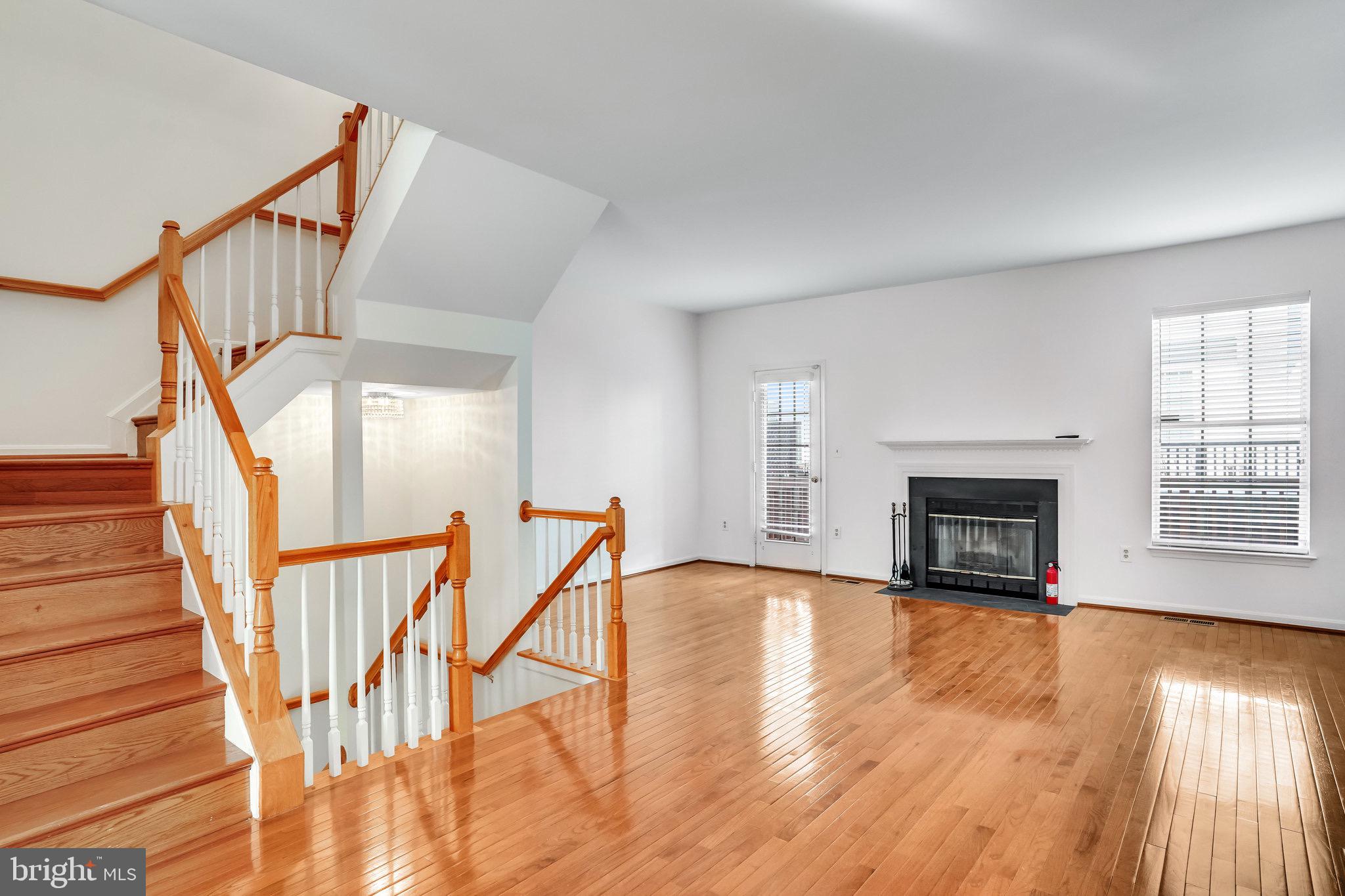 6324 Dakine Circle Springfield, VA 22150 - Photo 7 of 25 a view of an empty room with wooden floor fireplace and a window