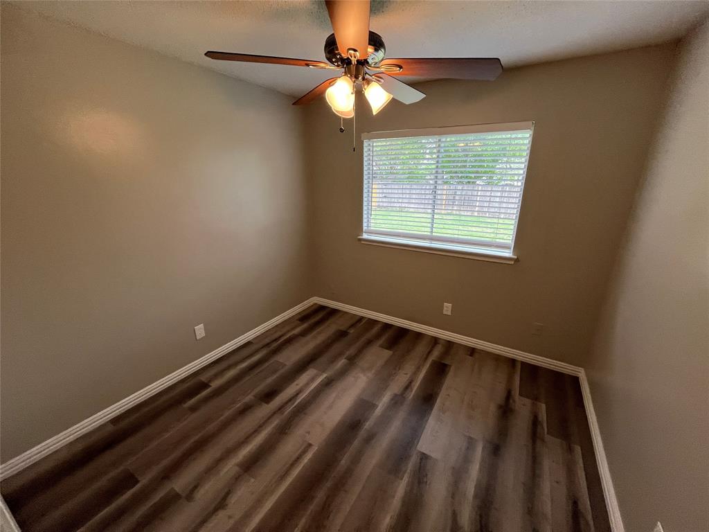 1413 Ridgecrest Drive Plano, TX 75074 - Photo 18 of 22 Unfurnished room featuring dark wood-type flooring and ceiling fan