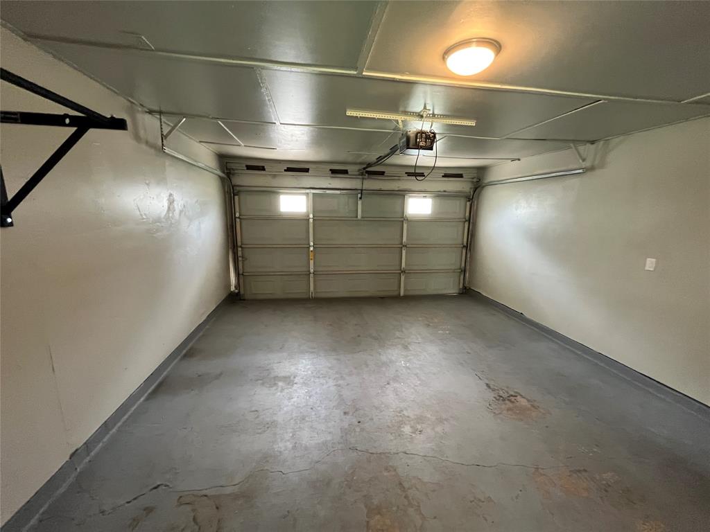 1413 Ridgecrest Drive Plano, TX 75074 - Photo 10 of 22 Garage with baseboards and a garage door opener