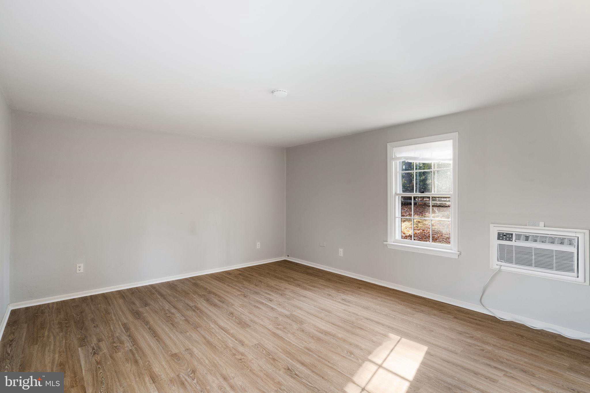 310 Pine Tree Road Wayne, PA 19087 - Photo 2 of 2 an empty room with wooden floor and windows