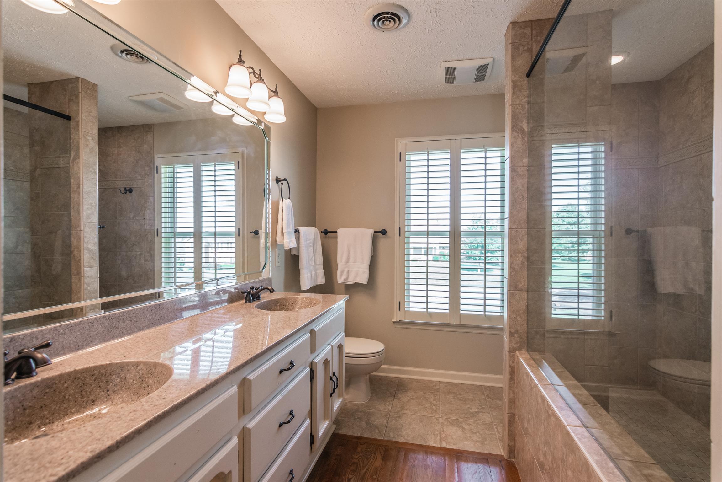 103 Crosspointe Hendersonville, TN 37075 - Photo 19 of 30 a spacious bathroom with double vanity a window a mirror a bathtub and shower