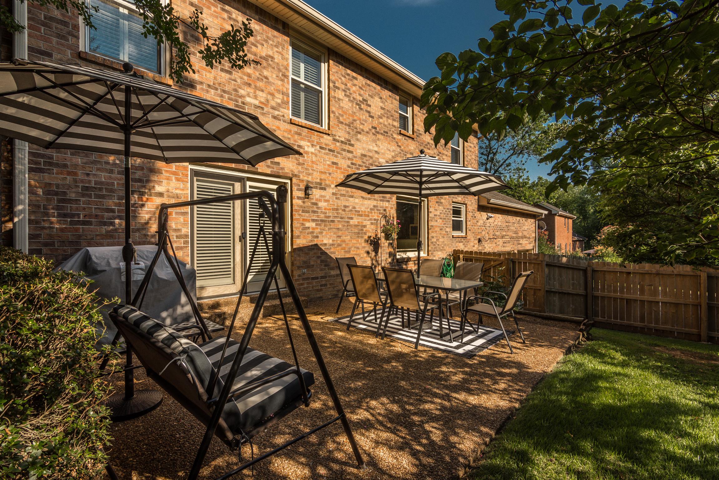 103 Crosspointe Hendersonville, TN 37075 - Photo 29 of 30 a view of a patio with table and chairs with wooden fence and plants