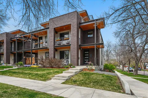 front view of a brick house with a yard