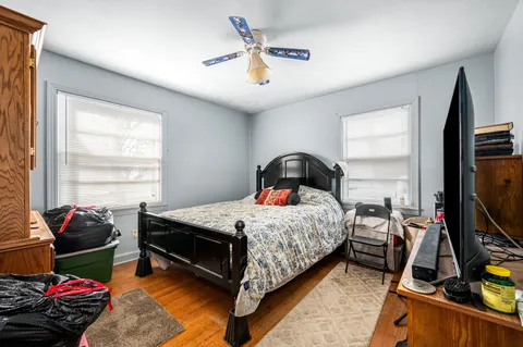 a bedroom with bed and a flat tv screen