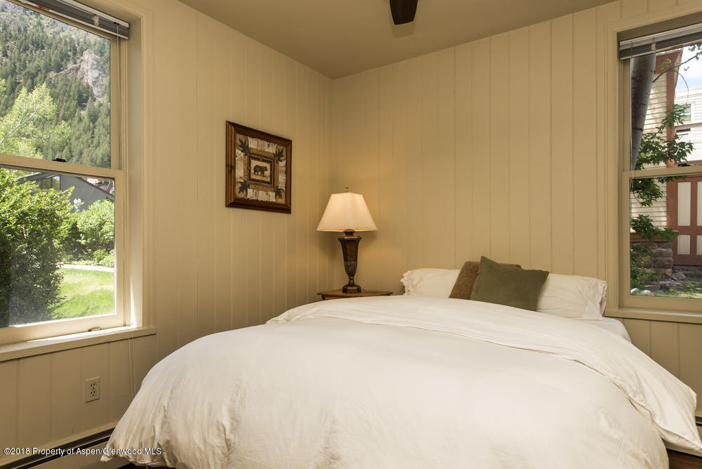 314 West Main Street Aspen, CO 81611 - Photo 11 of 20 a bedroom with a bed and a window