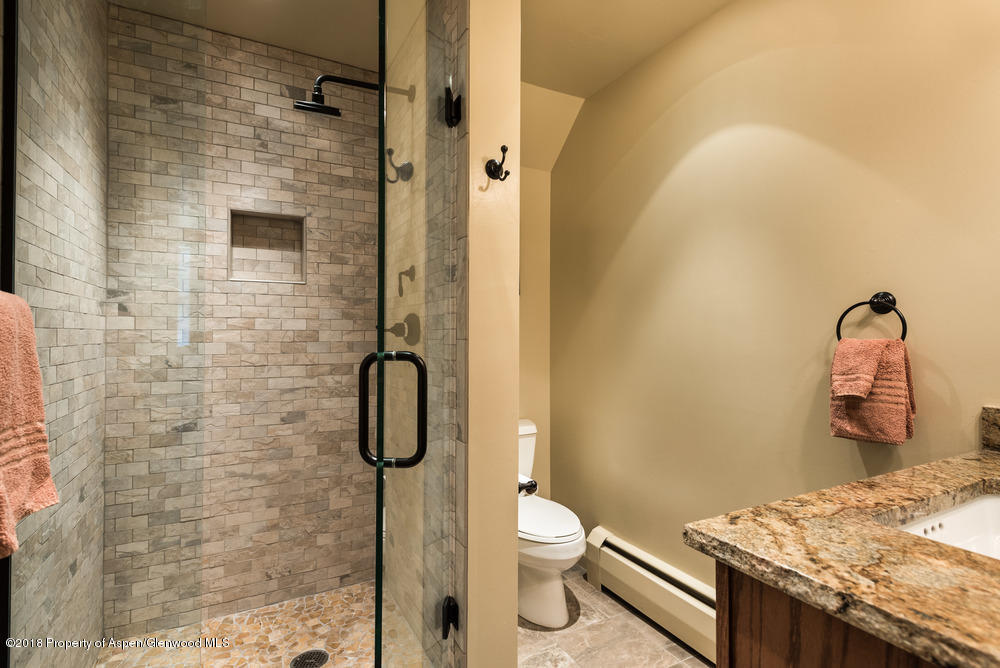 314 West Main Street Aspen, CO 81611 - Photo 12 of 20 a bathroom with a granite countertop sink a toilet and shower