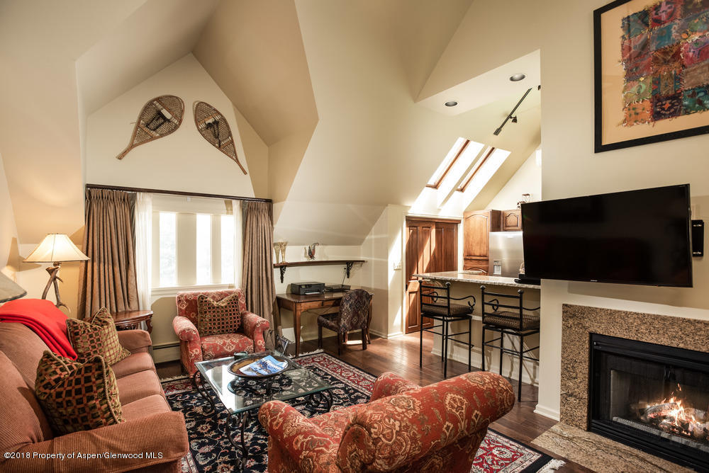 314 West Main Street Aspen, CO 81611 - Photo 2 of 20 a living room with furniture a fireplace and a flat screen tv