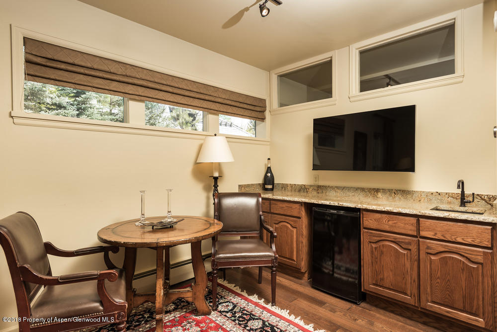 314 West Main Street Aspen, CO 81611 - Photo 8 of 20 a kitchen with stainless steel appliances kitchen island granite countertop a sink and cabinets