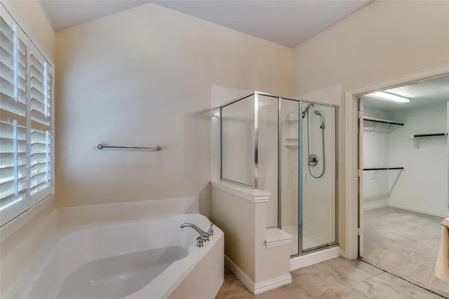 a bathroom with a bathtub and a shower