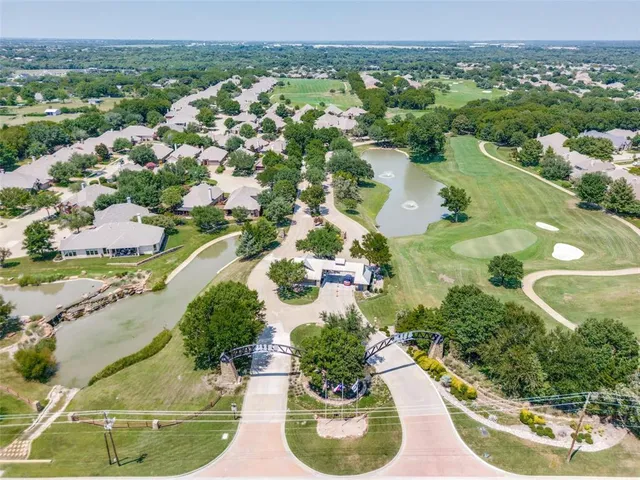 an aerial view of a house with a garden and lake view