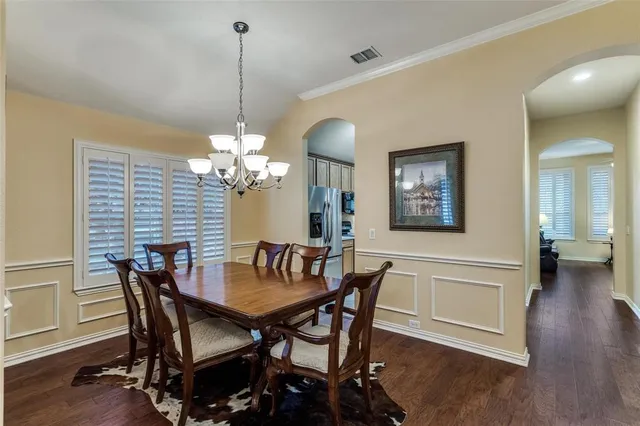 a view of a dining room with furniture wooden floor and chandelier