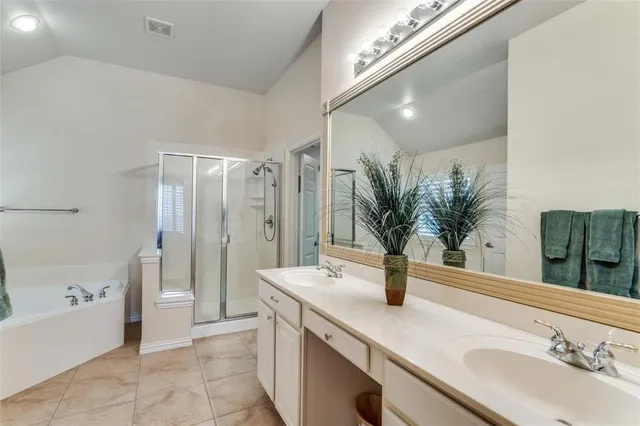 a bathroom with a tub sink and mirror