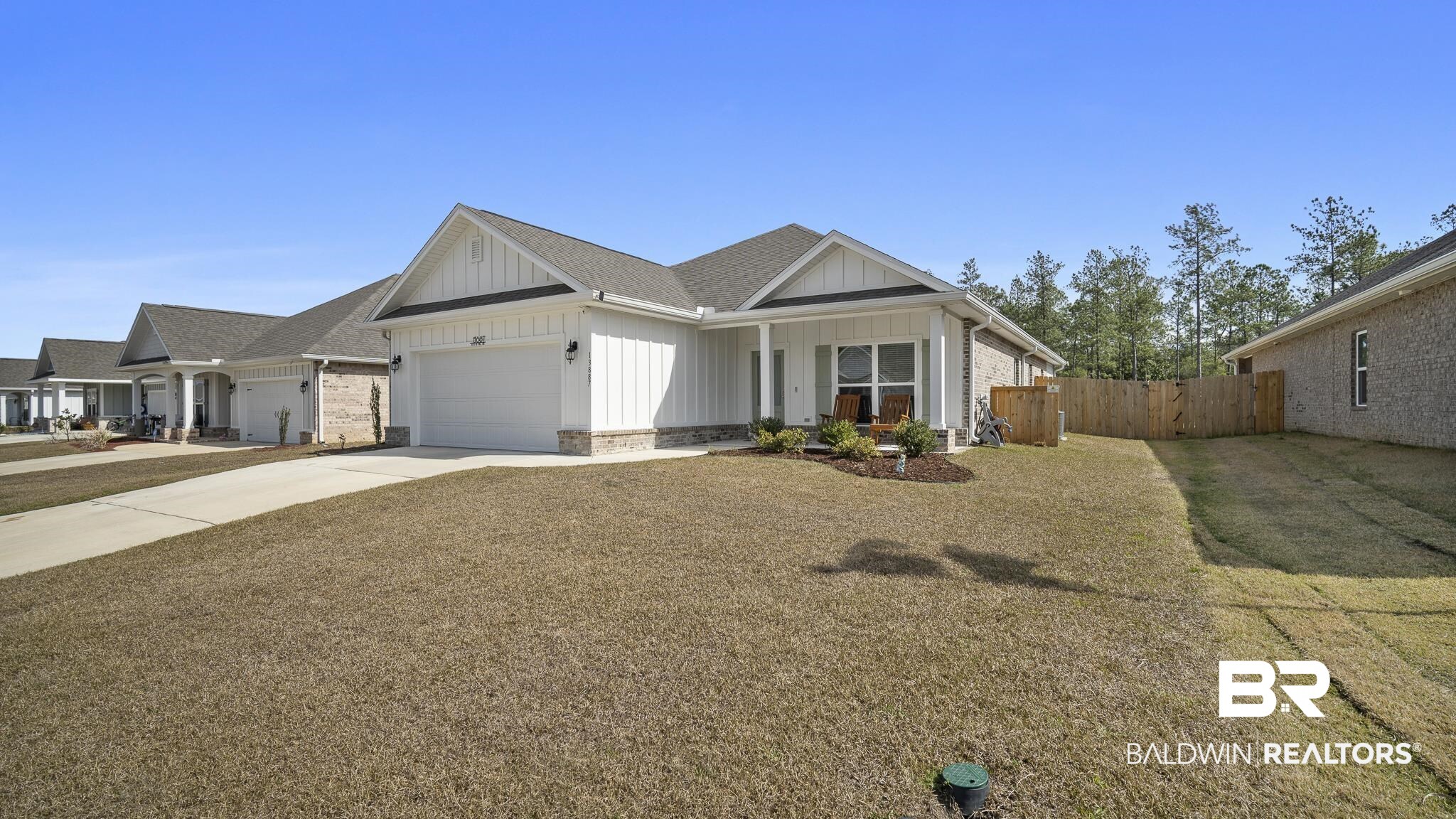 13887 Antler Hl Road Daphne, AL 36527 - Photo 2 of 50 View of front of home with board and batten siding, an attached garage, concrete driveway, and a porch