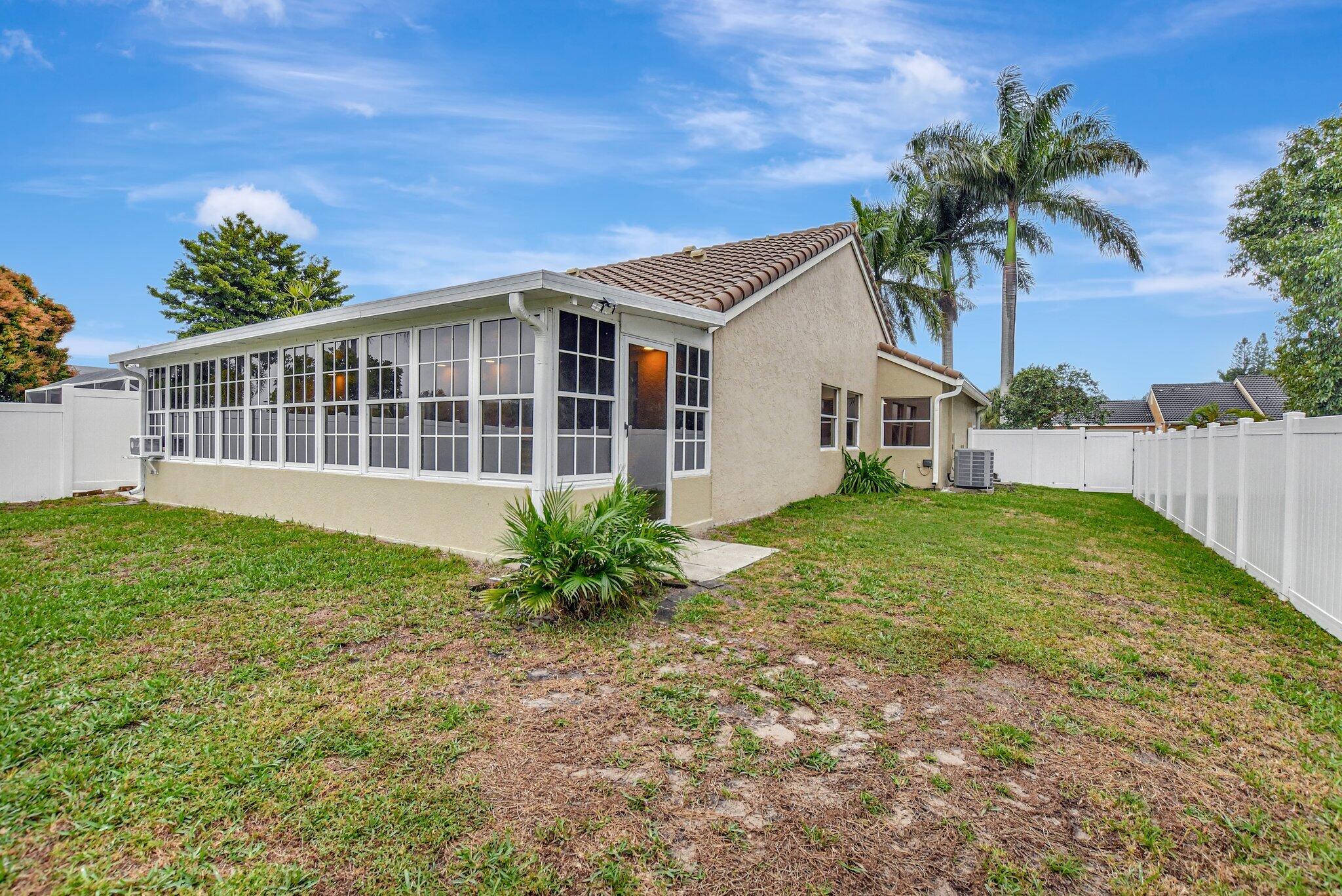 10230 Allegro Drive Boca Raton, FL 33428 - Photo 15 of 20 a front view of a house with a garden